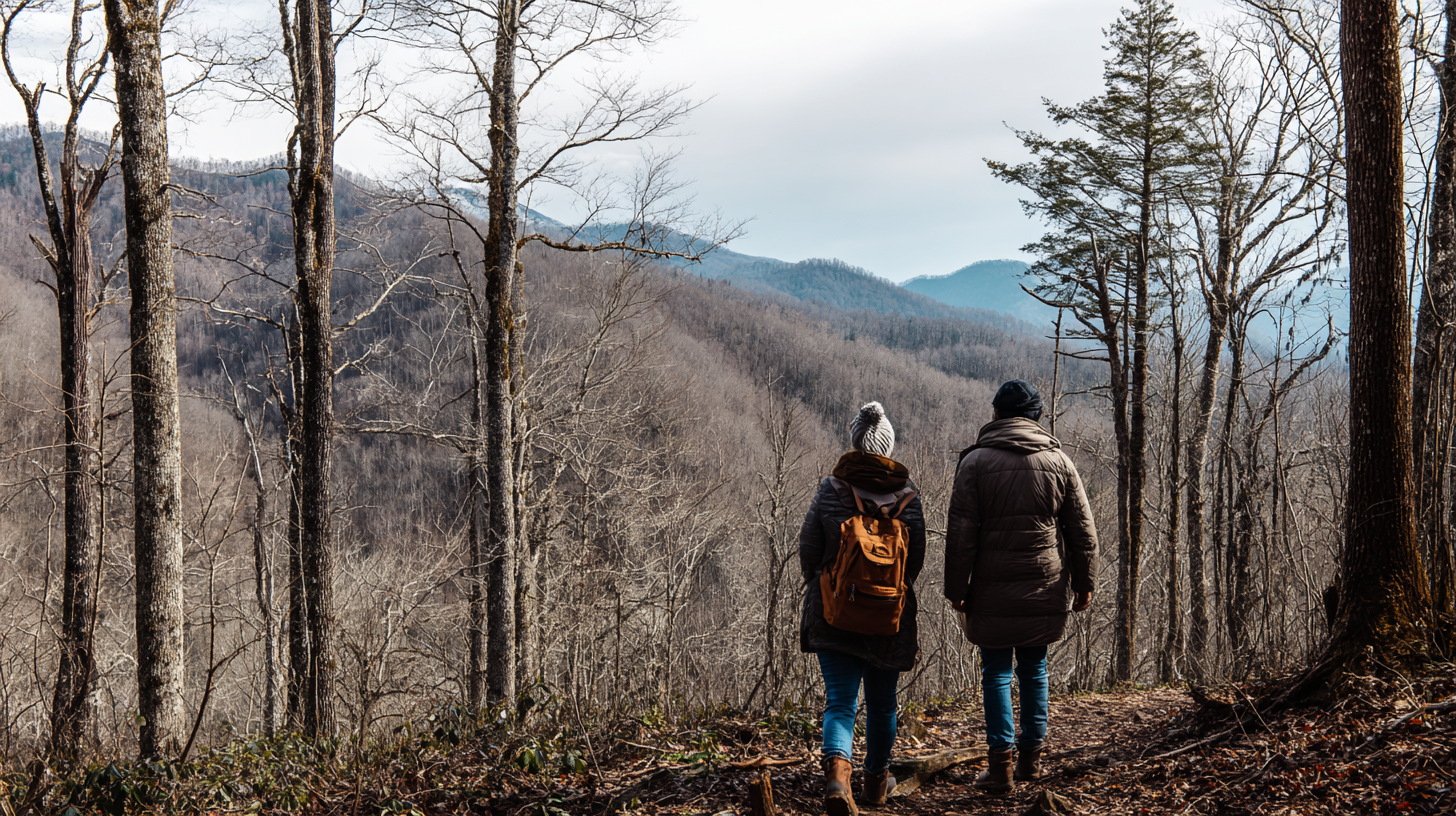 A couple hiking through leafless trees on a mountain trail during a winter outdoor adventure in the Great Smoky Mountains.